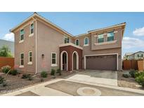 Charming two-story home featuring a brick arched entryway and attached two-car garage at 670 S Beebe St, Gilbert, AZ 85296