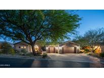 Charming home with a paver driveway, three-car garage and stone accents, all set beneath a twilight sky at 7130 E Saddleback St # 58, Mesa, AZ 85207