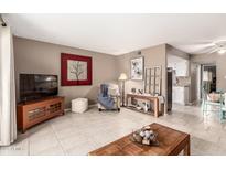 Inviting living room with neutral walls, tile floors, and decorative touches create a cozy atmosphere at 7436 E Chaparral Rd # 124B, Scottsdale, AZ 85250