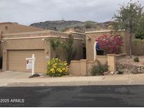 Charming single-story home with lush landscaping and a convenient two-car garage at 11052 N 10Th Pl, Phoenix, AZ 85020