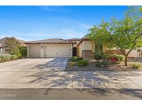 Charming home featuring a three-car garage and well-maintained landscaping at 18387 W Mountain Sky Ave, Goodyear, AZ 85338