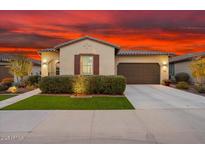 Inviting single-Gathering home with manicured lawn, desert landscaping, and attached two-car garage at 29344 N 132Nd Ln, Peoria, AZ 85383