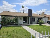 Charming single-story home featuring a well-maintained front yard with mature bushes and a welcoming entrance at 4507 E Saint Catherine Ave, Phoenix, AZ 85042