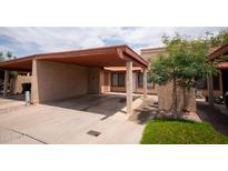 Spacious carport adjacent to the front entry of this home featuring neutral tones and a well-maintained landscape at 5217 N 18Th Dr, Phoenix, AZ 85015
