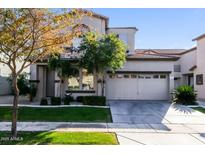 Charming two-story home with lush landscaping and a two-car garage at 5329 E Harmony Ave, Mesa, AZ 85206