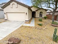 Charming single-story home with desert landscaping, attached two-car garage, and tiled roof at 6617 W Cavedale Dr, Phoenix, AZ 85083
