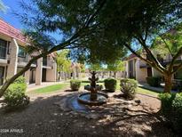 Beautiful courtyard with a fountain, lush landscaping, and access to the community pool at 700 W University Dr # 203, Tempe, AZ 85281