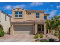 Charming two-story home with a tile roof, manicured landscaping, and an attached two-car garage at 9764 E Radioactive Dr, Mesa, AZ 85212