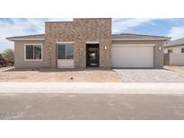Charming single-story home featuring a stone facade, gray stucco, and a two-car garage at 9775 S 36Th Ln, Laveen, AZ 85339
