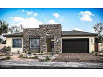 Contemporary single-story home featuring stone accents, a two-car garage, and desert landscaping at 9775 S 36Th Ln, Laveen, AZ 85339