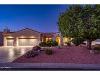 Inviting single-story home boasting a well-manicured front yard, mature tree, and a three-car garage at 12928 W Santa Ynez Dr, Sun City West, AZ 85375