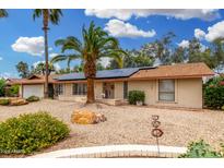 Charming single-story home with desert landscaping, solar panels and a brick facade at 134 E Le Marche Ave, Phoenix, AZ 85022