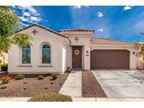 Charming single-story home with a well-manicured front yard and a cozy, inviting entryway at 14549 W Corrine Dr, Surprise, AZ 85379
