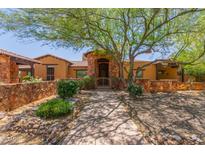 Stunning home featuring a secure gate, stone accents, and a well maintained desert landscape at 14619 E Desert Vista Trl, Scottsdale, AZ 85262