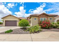 Charming home with well-manicured landscaping, stone accents, and a spacious two-car garage at 20642 N 268Th Dr, Buckeye, AZ 85396