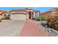 Charming home featuring a well-manicured front yard, a brick walkway, and a two-car garage at 2312 E Williams Dr, Phoenix, AZ 85024