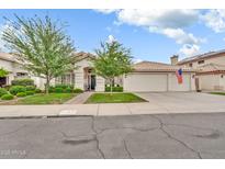 Charming single-story home featuring a well-manicured lawn and an attached three-car garage at 3440 E Topeka Dr, Phoenix, AZ 85050