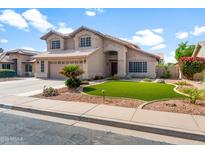 Inviting two-story home boasts a well-manicured lawn, beautiful landscaping, and a spacious two car garage at 4226 E Stanford Ave, Gilbert, AZ 85234