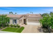 Beautiful single-story home featuring a three-car garage, stone accents, manicured landscaping, and tile roof at 5542 E Alan Ln, Paradise Valley, AZ 85253