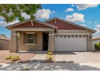 Charming single-story home with a well-maintained front yard and a two-car garage at 10352 E Sebring Ave, Mesa, AZ 85212