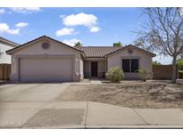 Charming single-story home with a well-maintained front yard and a two-car garage at 10923 E Flower Ave, Mesa, AZ 85208