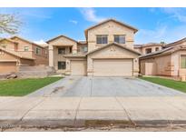 Charming two-story home featuring a 2-car garage, low maintenance landscaping, and neutral color palette at 13304 W Stella Ln, Litchfield Park, AZ 85340