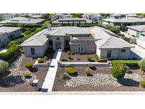 A modern home boasts a beautifully landscaped front yard with pavers leading to the front door at 2735 E King Bird Dr, Gilbert, AZ 85297