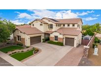 Expansive two-story home featuring a three-car garage, meticulously landscaped yard, and a classic tile roof design at 2851 E Alexander Ct, Gilbert, AZ 85298