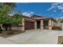Charming single-story home featuring a well-manicured lawn, a two-car garage, and a cozy front porch at 4273 S Red Rock St, Gilbert, AZ 85297