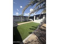 Inviting backyard featuring artificial turf, stone accents and walkways, offering a low-maintenance outdoor space at 1524 E Cortez St, Phoenix, AZ 85020