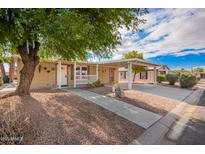 Inviting home exterior featuring covered parking, desert landscaping, and a charming front porch at 155 E Rodeo Rd # 64, Casa Grande, AZ 85122