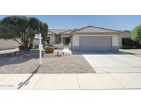 Charming home featuring a tile roof, low-maintenance desert landscaping, and a two-car garage at 19507 N Hidden Canyon Dr, Surprise, AZ 85374