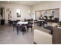 Cozy residents' lounge features tables and chairs and a view to an outdoor patio and bar at 2121 W Sonoran Desert Dr # 43, Phoenix, AZ 85085