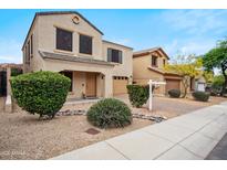 Charming two-story home with beautiful landscaping and a warm, inviting facade at 2323 W Hunter Ct, Phoenix, AZ 85085