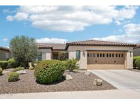 Charming single-story home with desert landscaping, a tile roof and a two-car garage at 27320 N 127Th Dr, Peoria, AZ 85383