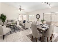 Bright living room featuring neutral furniture, tile flooring, and a ceiling fan at 280 W Sheffield Ave, Gilbert, AZ 85233