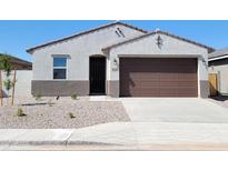 Charming single-story home featuring a brown two car garage and low maintenance desert landscaping at 37139 W Prado St, Maricopa, AZ 85138