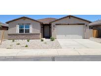 Charming single-story home featuring a stucco exterior, stone accents, and a two-car garage at 37154 W La Paz St, Maricopa, AZ 85138