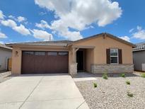 Charming single-story home with a well-maintained front yard, desert landscaping, and a two-car garage at 37399 W San Sisto Ave, Maricopa, AZ 85138