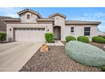 Charming single-story home featuring a well-manicured front yard and a two car garage at 4960 E Villa Theresa Dr, Scottsdale, AZ 85254