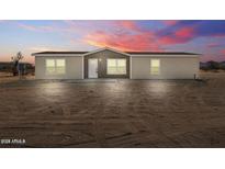 Charming single-story home featuring board and batten siding, and a well-manicured front yard at 52002 W Sotol Rd, Maricopa, AZ 85139