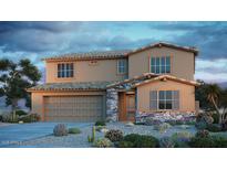 Charming two-story home featuring a neutral color scheme, stone accents, and a well-manicured desert landscape at 5235 W Walatowa St, Laveen, AZ 85339