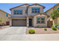 Two-story home with a brown two-car garage, desert landscaping, and neutral paint scheme at 1081 E Armstrong Way, Chandler, AZ 85286