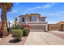 Beautiful two-story home featuring a Spanish tile roof, desert landscaping, and a two-car garage at 11049 N 111Th Way, Scottsdale, AZ 85259