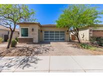 Charming single-story home featuring a brick driveway and desert landscaping at 12083 W Peak View Rd, Peoria, AZ 85383
