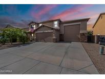 Beautiful two-story home with a three-car garage and well-manicured front yard at 12238 W Patrick Ct, Sun City, AZ 85373