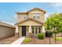 Charming two-story home featuring a covered front porch and low-maintenance landscaping at 13380 N 148Th Ave, Surprise, AZ 85379