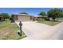 Charming single-story home with a two-car garage and well-maintained front yard at 19018 N Concho Cir, Sun City, AZ 85373
