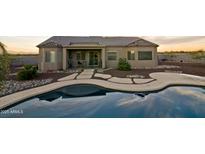 Inviting backyard pool and patio area, ideal for relaxing and entertaining in this desert home at 300 W Quartz Rock Rd, Phoenix, AZ 85085