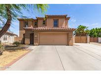 Beautiful two-story home with a spacious driveway and a tile roof, showcasing its attractive curb appeal at 304 E Beth Dr, Phoenix, AZ 85042